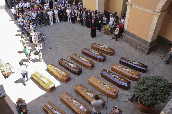 Coffins of 13 unidentified migrants who died in the April 19, 2015, shipwreck are seen during a funeral service in Catania, Italy, on July 7, 2015. Some 800 people reportedly drowned off the coast of Libya in the catastrophe, in one of the worst migrant shipwrecks ever recorded.