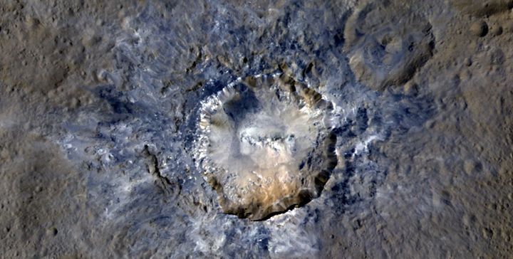 An enhanced color view of the Haulani Crater on Ceres taken by NASA's Dawn spacecraft from a distance of 915 miles.