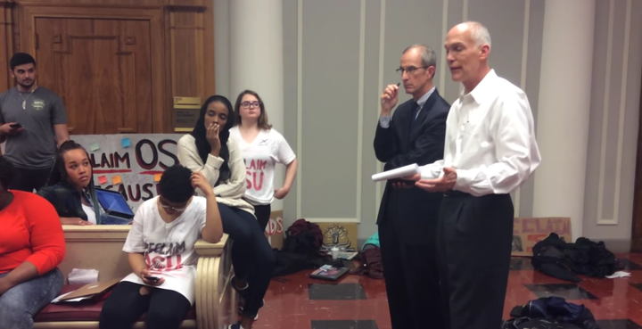 An unnamed university manager speaks to protestors at Ohio State