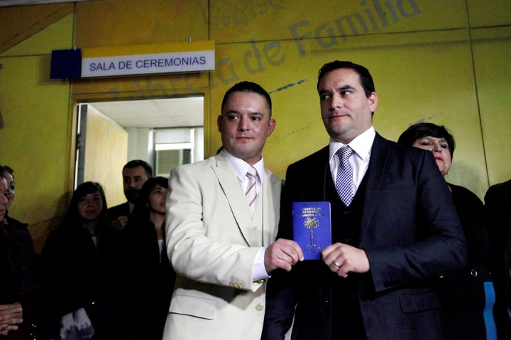 The couple pose with their civil union identification booklet.