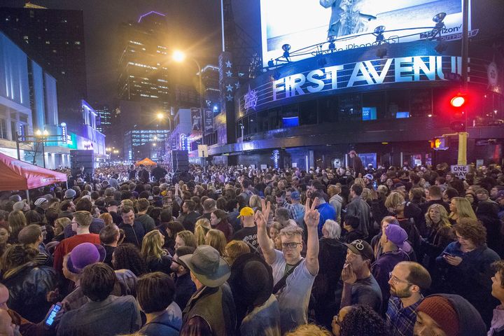 People listen to Prince music during a memorial street party outside the First Avenue nightclub