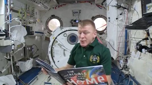 Tim Peake reading Roraigh's book from the International Space Station
