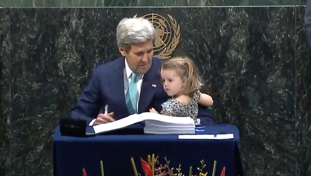 Secretary of State John Kerry signed the Paris agreement with his granddaughter in his arms.