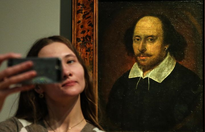 A woman takes a selfie in front of a portrait of William Shakespeare on April 21, 2016 in Moscow. April 23 is the 400th anniversary of the wordsmith's death.