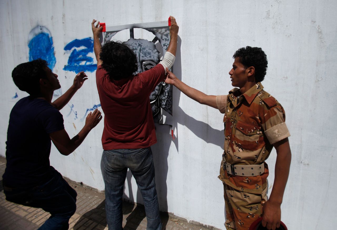 The campaign drew the attention of the authorities. Above, a soldier tries to stop Subay painting a portrait of one of the disappeared in September 2012.