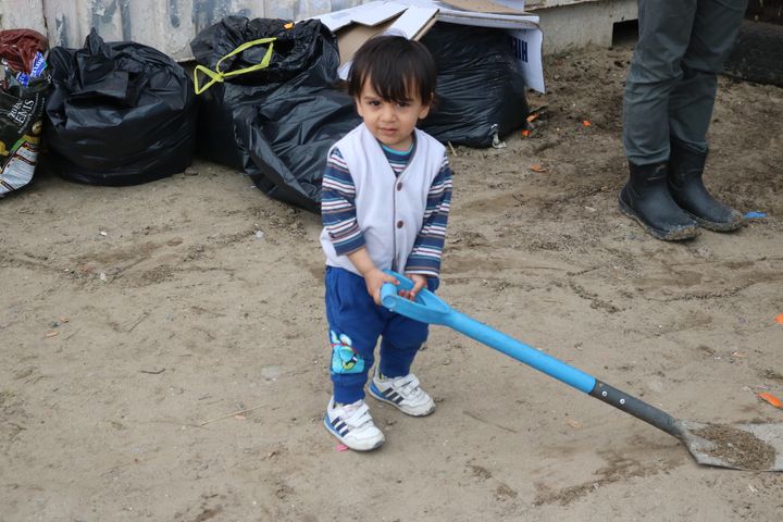 A two-year-old Afghan boy plays outside the women and children's centre