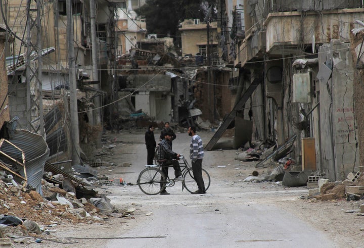 Journalist Rahaf Haboub recalls her family's harrowing journey out of Daraya, a Damascus suburb besieged by pro-government forces, in 2012. Two men chat amid the city's ruins.