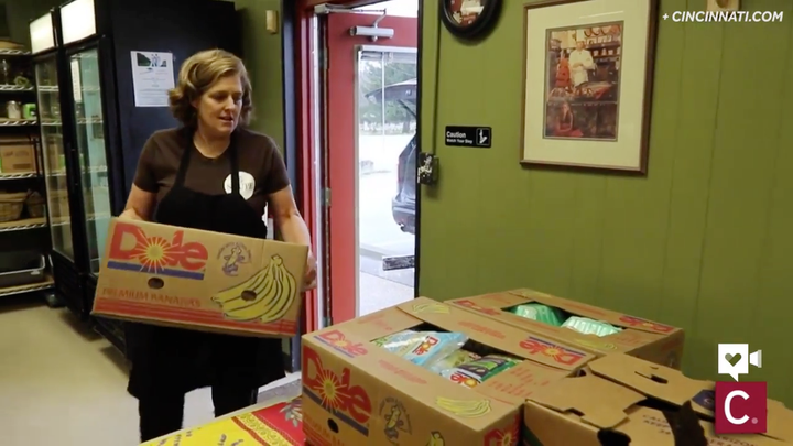 Chef Suzy DeYoung carrying in a box of donations.