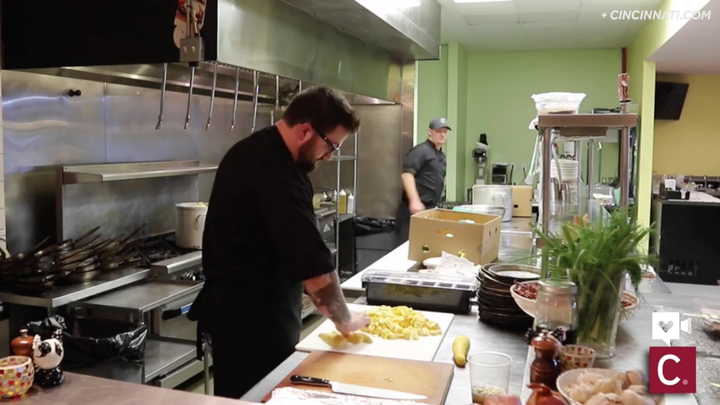 Volunteer chefs prep produce for soup.