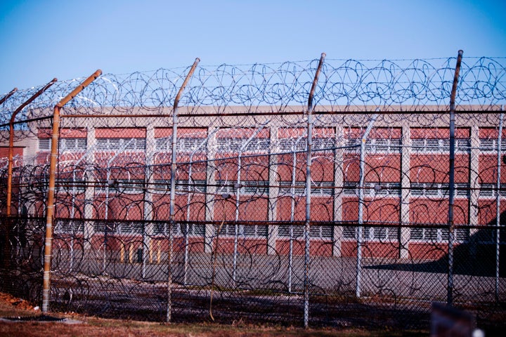 Barbed wire fence surrounds a building at new York's Rikers Island Correctional Facility in 2013.