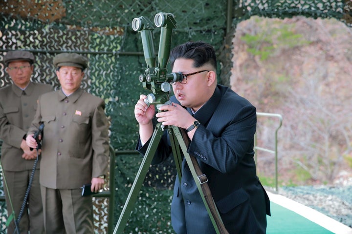 Kim Jong Un guides on the spot the underwater test-fire of strategic submarine ballistic missile in this undated photo releas