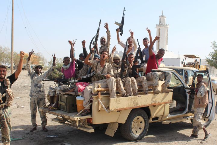 Forces loyal to the Saudi-backed Yemeni president flash their arms at a road on the entrance to Abyan province as they take part in an operation to drive Al Qaeda fighters out of the southern provincial capital.