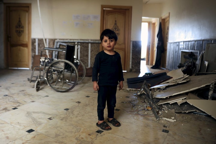 A boy, who was evacuated with others from two rebel-besieged towns of Foua and Kefraya in the northwestern province of Idlib, is seen standing inside a hospital that was struck by an explosion on the outskirts of the Sayeda Zeinab district south of Damascus, Syria, April 25, 2016.