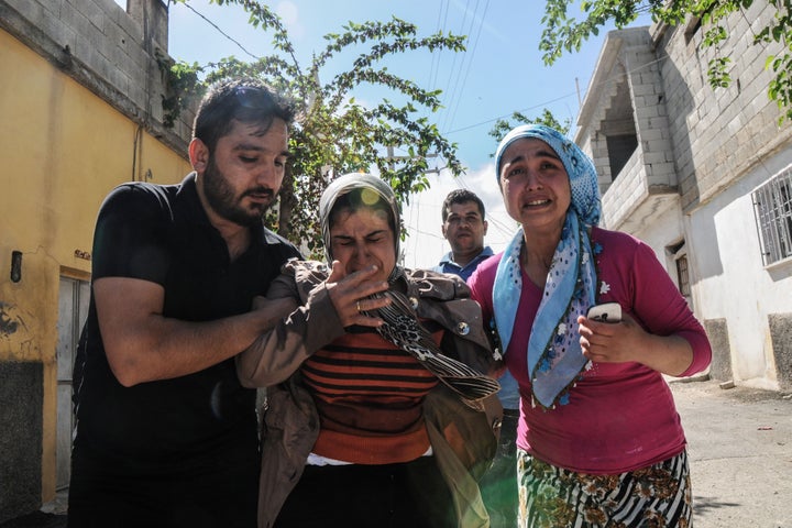 Residents flee as rockets fired from Islamic State-controlled Syria land in the Turkish border city of Kilis on April 19.