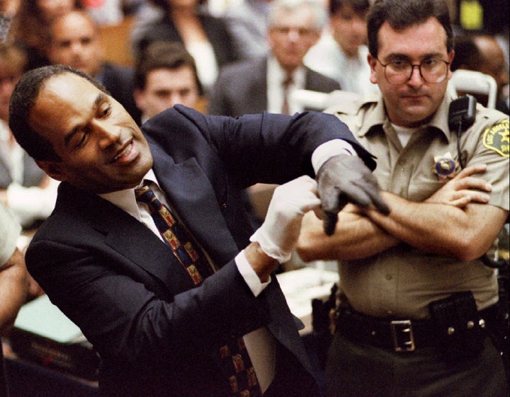 O.J. Simpson tries on "the gloves" during his murder trial.