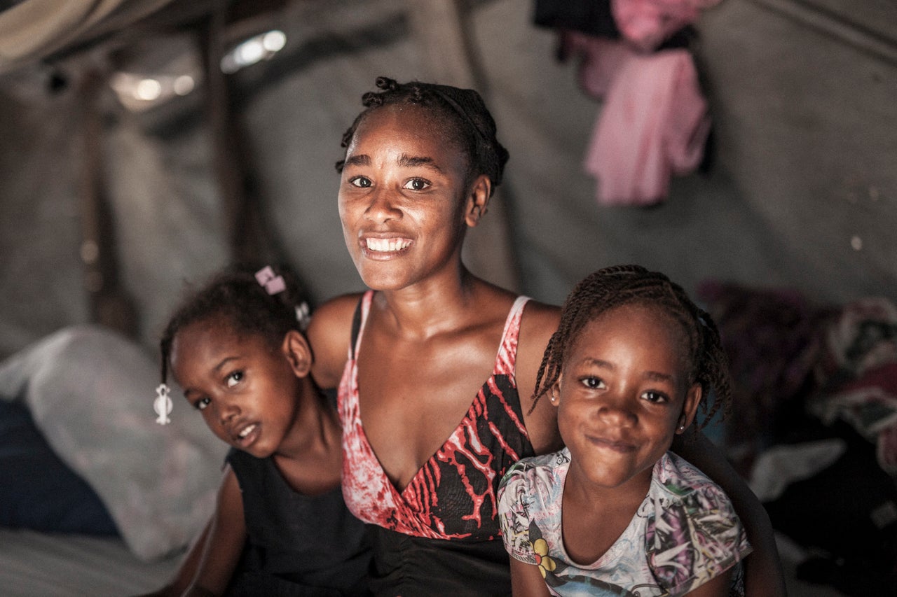 According to Carron, Marie-Sherline (with her two girls above) had her left leg amputated after the 2010 earthquake in Haiti.