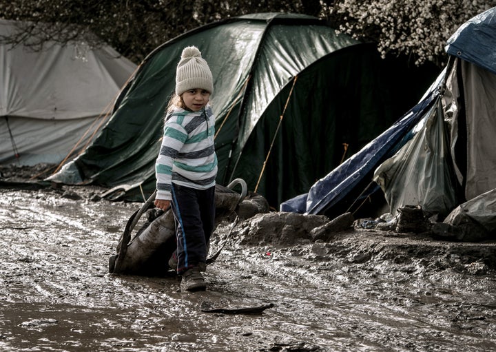 A child walks in the Jungle refugee camp in Grande Synthe, near Dunkirk, France