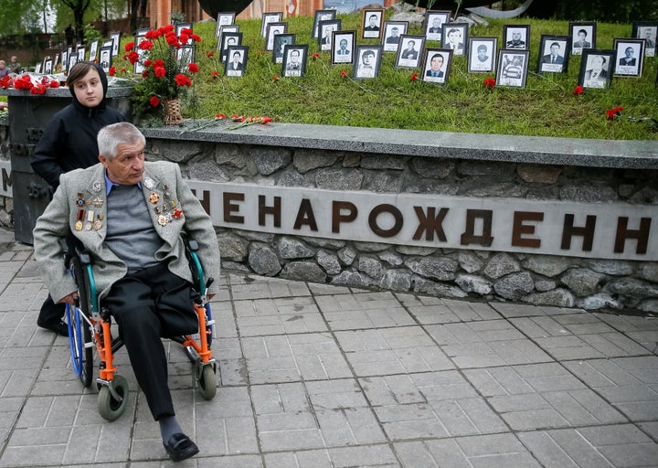 A rescue worker who served during the Chernobyl nuclear disaster attends a commemoration ceremony in Kiev. Over half a million civilians and military personnel were drafted in to help clean up and contain the disaster.