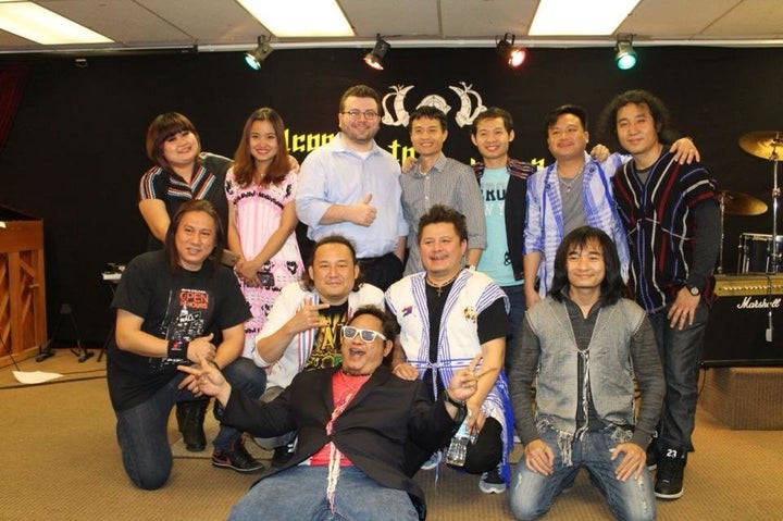 The Klo & Kweh Music Team pose with band manager Eh Wah (center) and Institute for Justice attorney Dan Alban (center, with glasses) following a recent performance in Bakersfield, California.