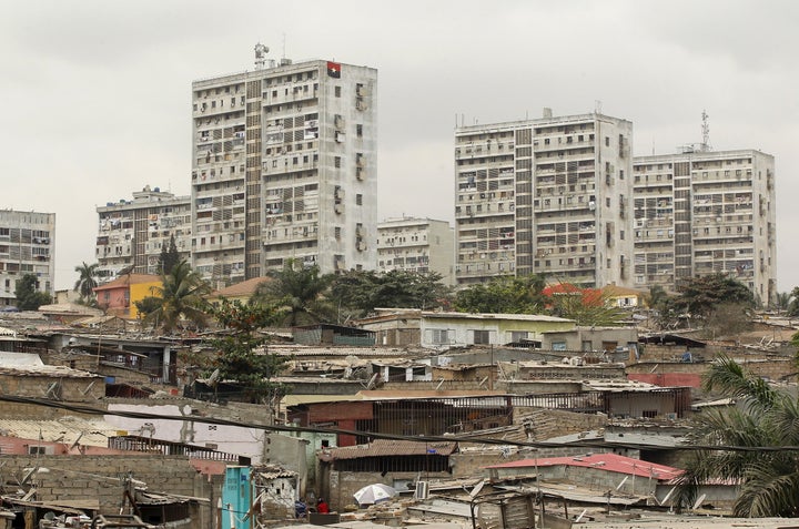 High-rise buildings are seen behind informal settlements in Luanda, Angola, where a yellow fever outbreak has health experts worried.