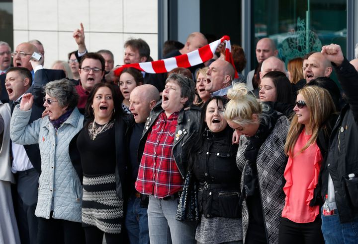Relatives of those who died in the Hillsborough disaster sing You'll Never Walk Alone outside the the inquest