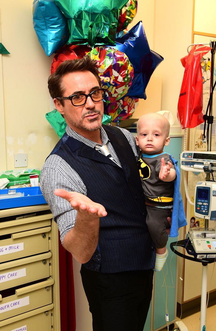 Robert Downey Jr. holds Charlie Dawson, 1, from Southend-on-Sea, Essex.