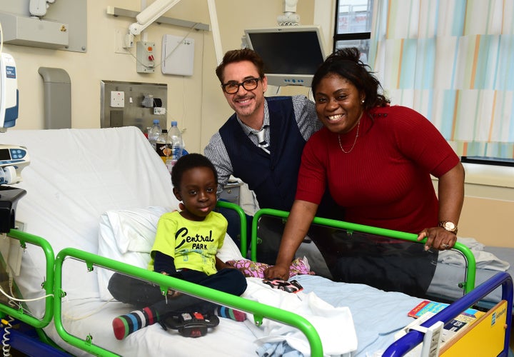 Robert Downey Jr. (centre) meets Michael, aged 7 from Edmonton, during a visit to Great Ormond Street Hospital (GOSH), in London.