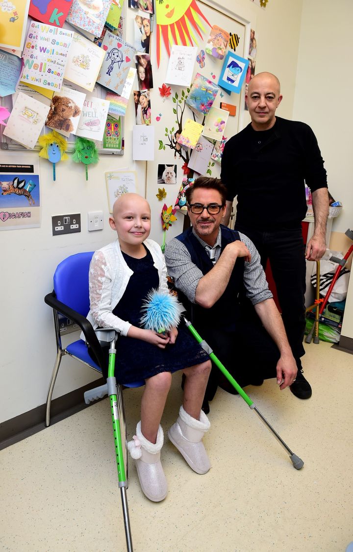Robert Downey Jr. (centre) with Denisa Kapsalis, aged 7 from London.
