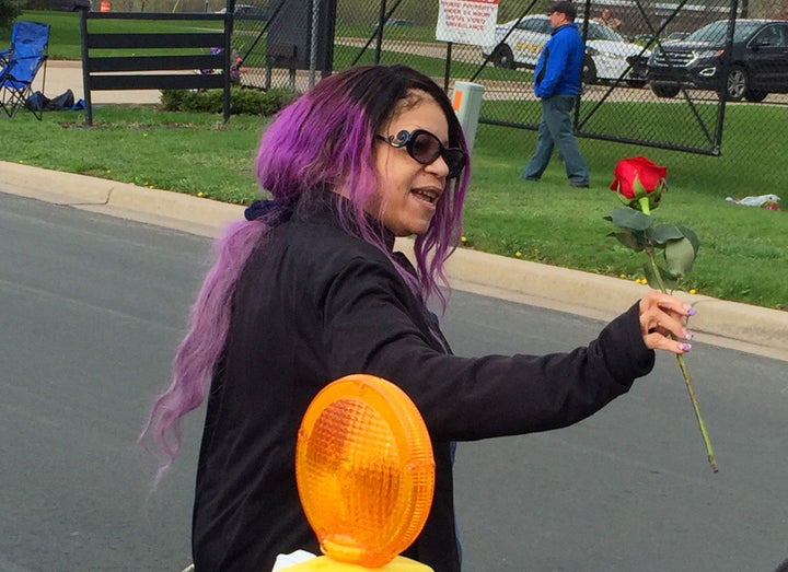 Tyka Nelson holds a rose outside Paisley Park, the home of her brother Prince in Chanhassen, Minn., on Thursday, April 21, 2016. Nelson went out to thank fans who gathered at the home to mourn the loss of the pop star who died Thursday.