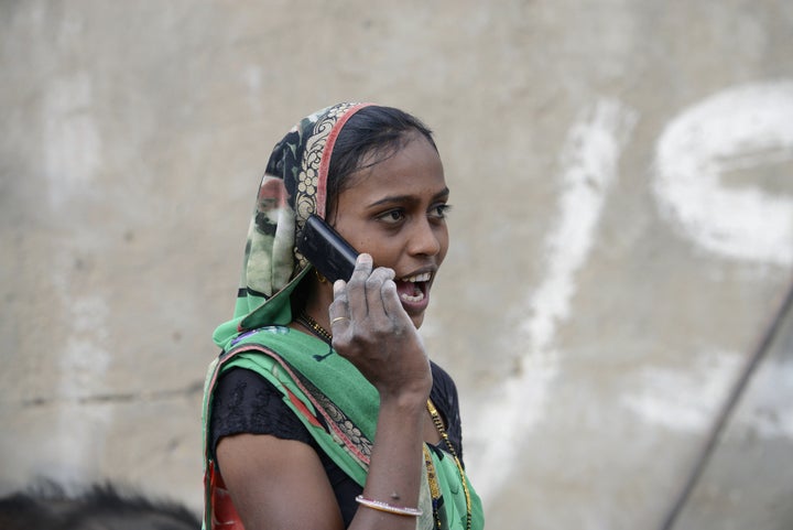 An Indian woman speaks on a mobile phone in Suraj village in Mehsana district, some 100 km from Ahmedabad, on February 20, 2016. A village in Indian Prime Minister Narendra Modi's home state of Gujarat has banned single women from using mobile phones, with elders deeming the technology a 'nuisance to society'. AFP PHOTO / Sam PANTHAKY / AFP / SAM PANTHAKY (Photo credit should read SAM PANTHAKY/AFP/Getty Images)