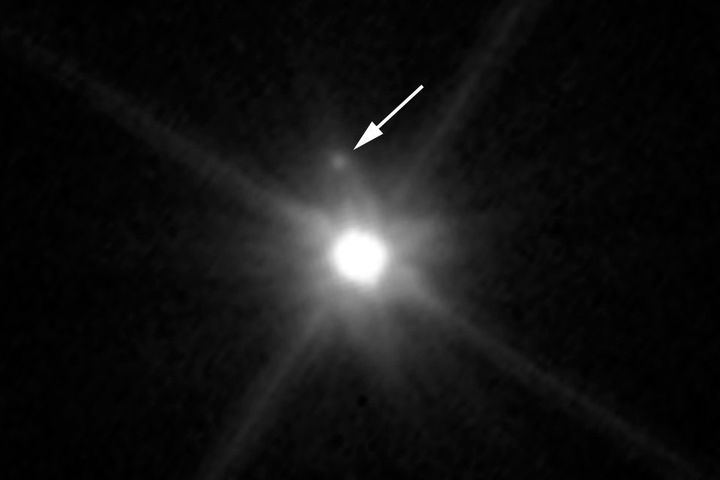 This Hubble Space Telescope image reveals the first moon ever discovered around the dwarf planet Makemake. The tiny moon, located just above Makemake in this image, is barely visible because it is almost lost in the glare of the very bright dwarf planet.