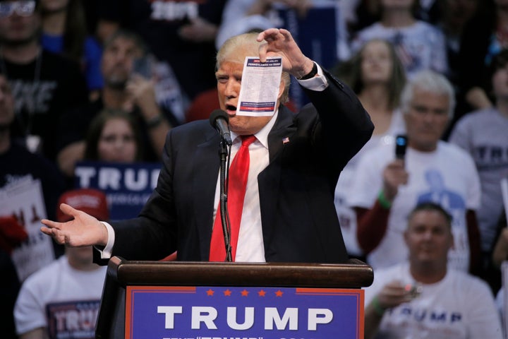 Republican U.S. presidential candidate Donald Trump shows the delegates list for the Pennsylvania state primary election during a rally in Wilkes-Barre, Pennsylvania, on Monday.