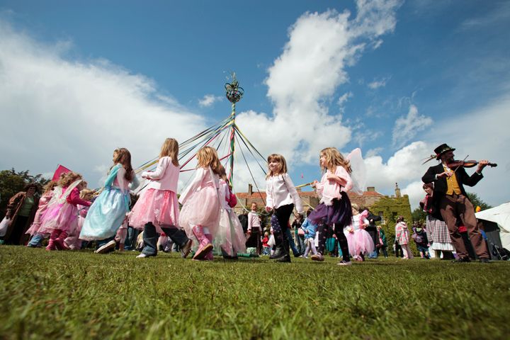 Children dance around a maypole