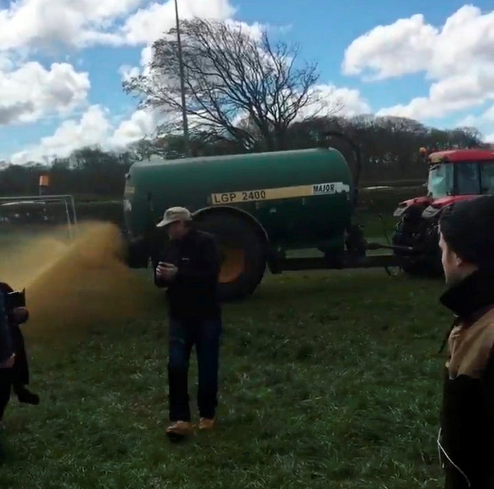 The manure is sprayed around anti-fracking protesters