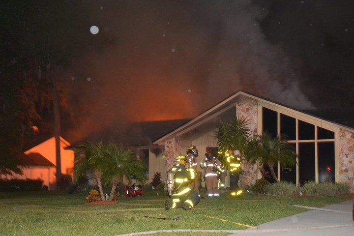 Firefighters are seen at the home of a Seminole County Sheriff's deputy Monday night after a fire broke out behind the house.