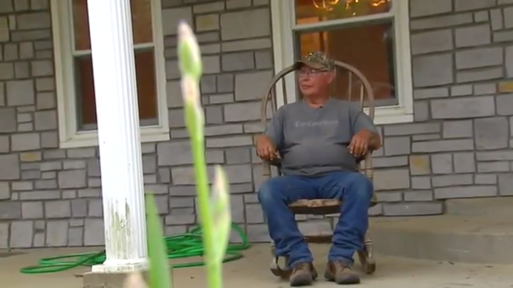 Martinez sitting n the porch of his new home.