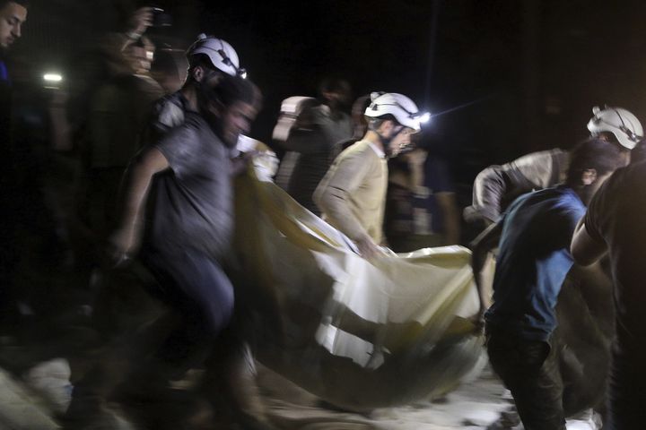 Civil defense members carry a casualty after an airstrike at a field hospital in Aleppo, Syria.