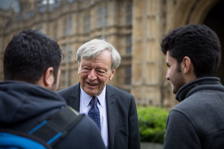 Lord Dubs meets two child refugees outisde parliament on Monday