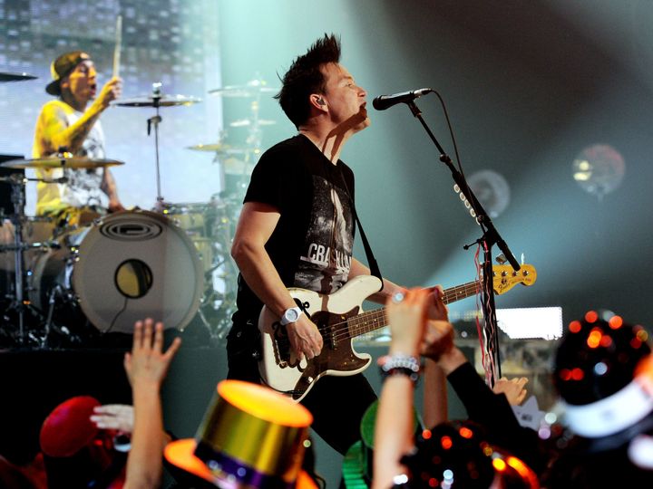 Musicians Travis Barker (L) and Mark Hoppus of Blink 182 perform on Dick Clark's New Year's Rockin' Eve on Dec. 31, 2011 in Los Angeles, California.