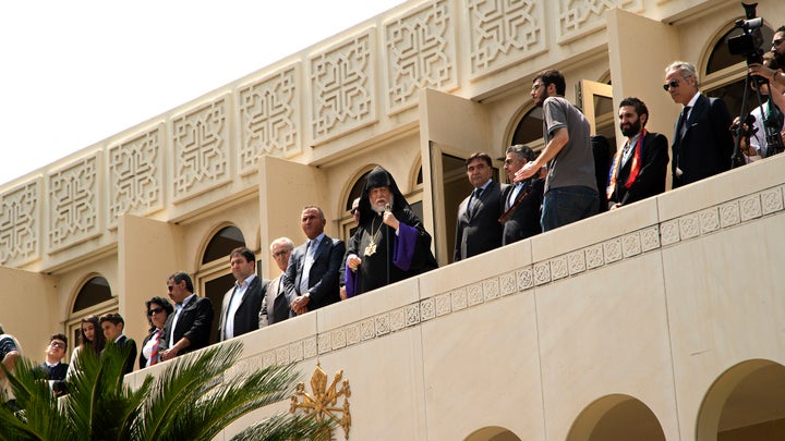 Aram I Keshishian (pictured centre), the head of the Holy See of Cilicia of the Armenian Apostolic (Orthodox) Church, watches the genocide commemoration ceremony taking place on the church grounds.