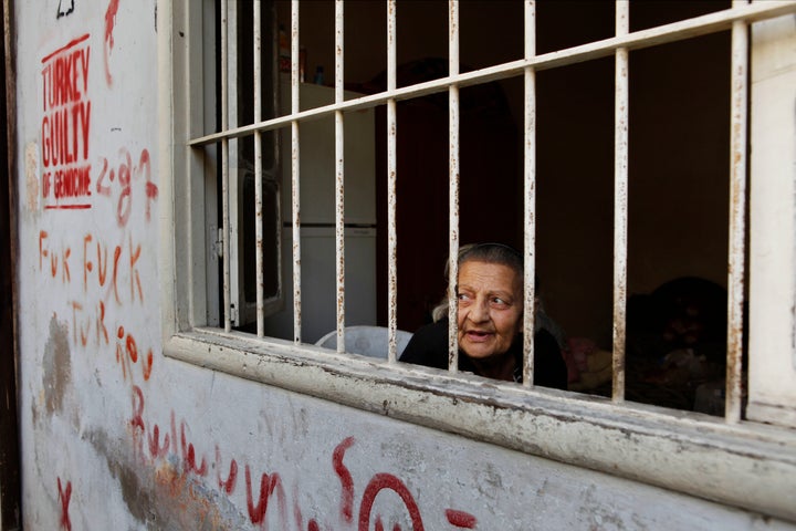 Imo Vik watches the day go by from her bedroom window in a back alley in central Bourj Hammoud.