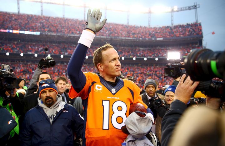 Peyton Manning waves to the crowd after the AFC Championship football game against the New England Patriots at Sports Authority Field at Mile High.