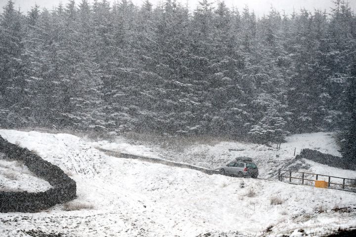 <strong>A car drives through snow near Nenthead in Cumbria</strong>