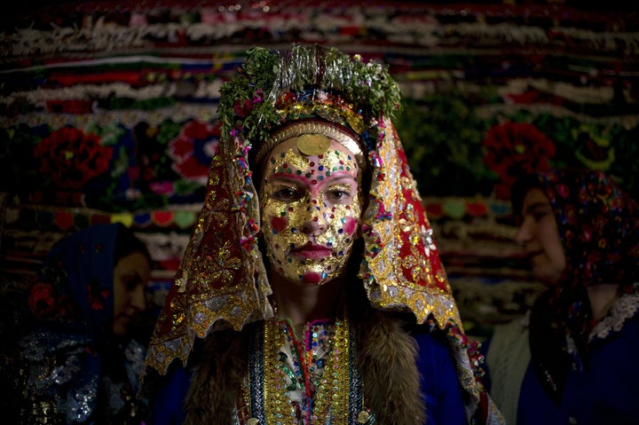 Emilia Pechinkova, a 24-year-old Bulgarian Pomak bride poses for a photograph following a face painting ceremony in the village of Draginovo, southeast of the capital Sofia on April 22, 2016.