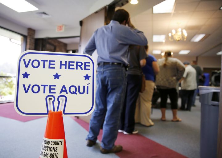 Voters stand in line to cast their primary ballots inside Calvary Baptist Church on Super Tuesday, March 1, 2016, in Rosenberg, Texas.