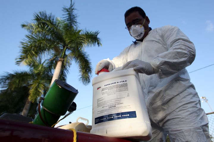 A health worker prepares insecticide before fumigating in a neighborhood in San Juan in January.