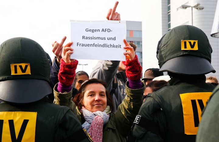 A protestor holds a banner reading 'Against AfD racism and misogyny' on Saturday. Hundreds of demonstrators temporarily blocked access to the anti-immigration party's conference.