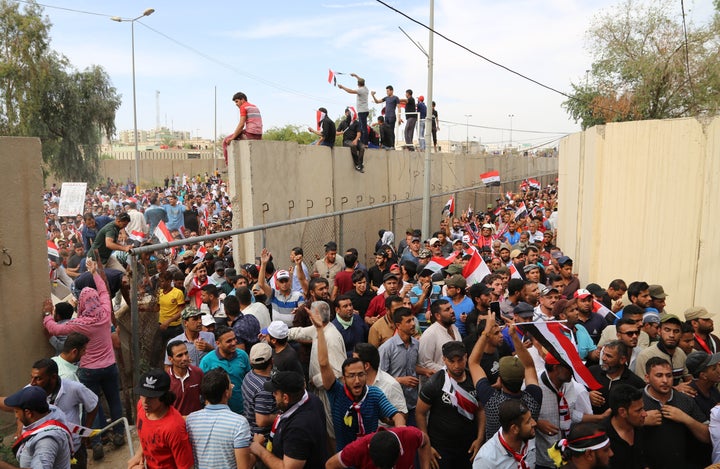 Sadr supporters enter the highly-fortified Green Zone in Baghdad on Saturday. A United Nations spokesman and four Western diplomats based inside the Green Zone said their compounds were locked down.