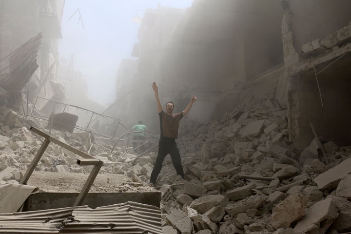 A man stands amid the rubble of an airstrike on Aleppo on Thursday. The escalating violence has all but destroyed the ceasefire deal brokered in February.