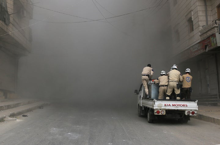 Civil defense workers and civilians carry out search and rescue operations after airstrikes in Aleppo. On Saturday, the International Committee for the Red Cross said aid had begun to enter the besieged Syrian towns of Zabadani and Madaya.